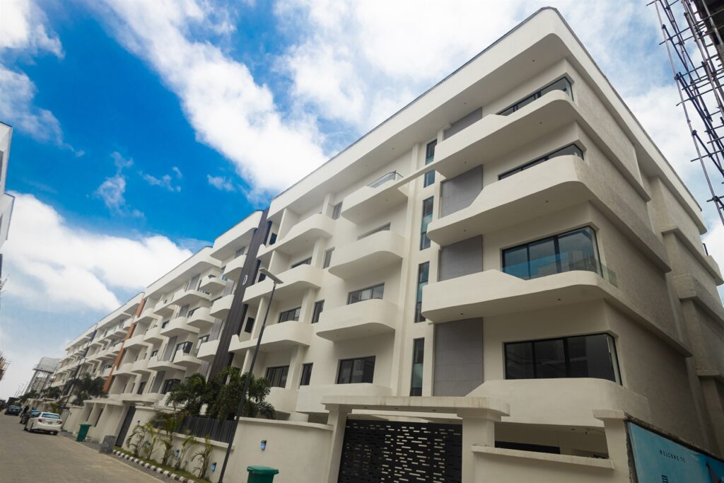 Brum Height 7: Street view of the white residential building and curved balconies